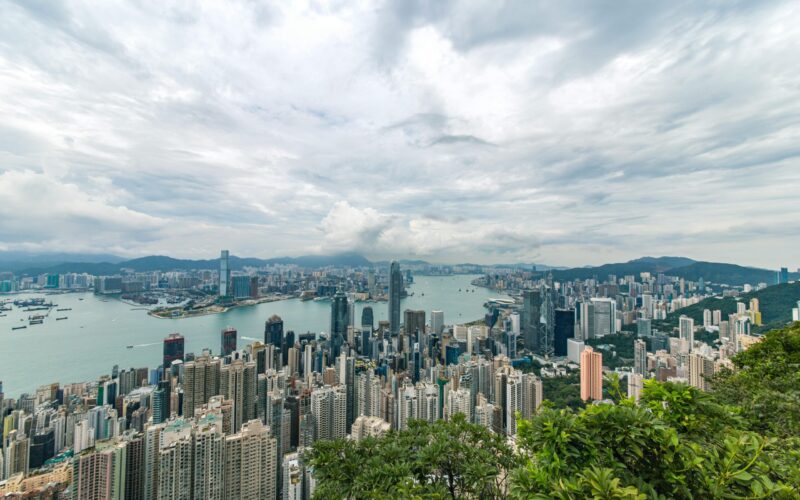 A breathtaking aerial panorama of Hong Kong's iconic skyline with towering skyscrapers and Victoria Harbour.